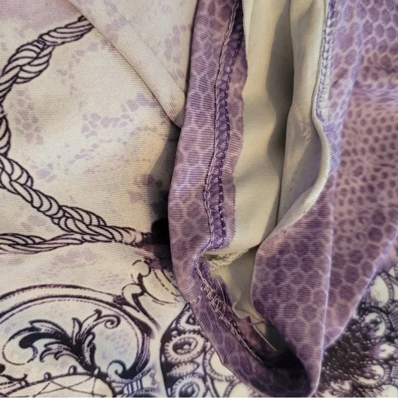 Short sleeve purple top with design. Material is loose fitting. - Picture 3 of 3